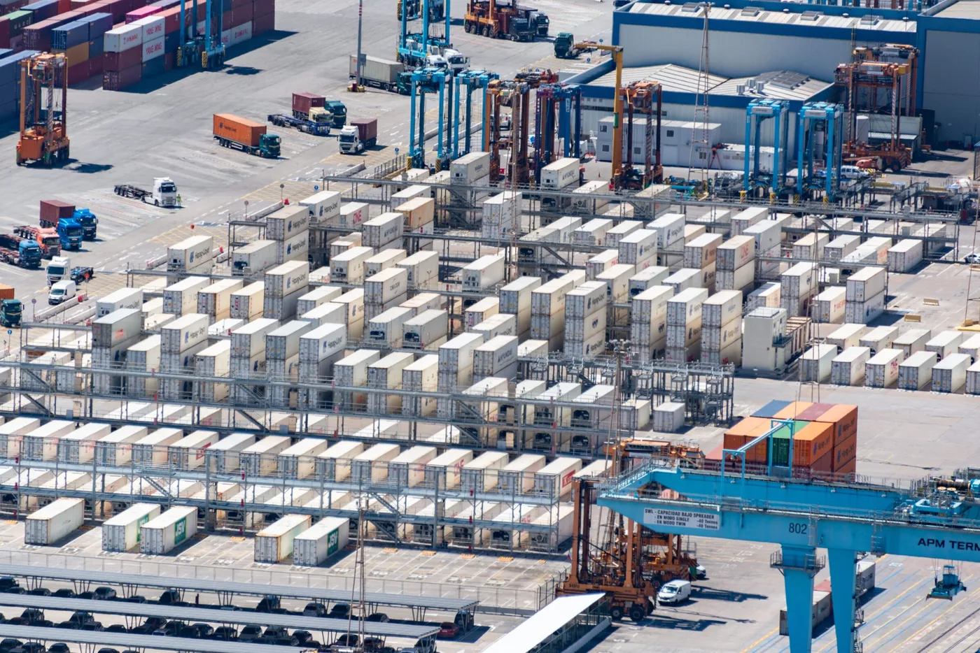 Aerial view of a logistics warehouse with shipping containers and trucks
