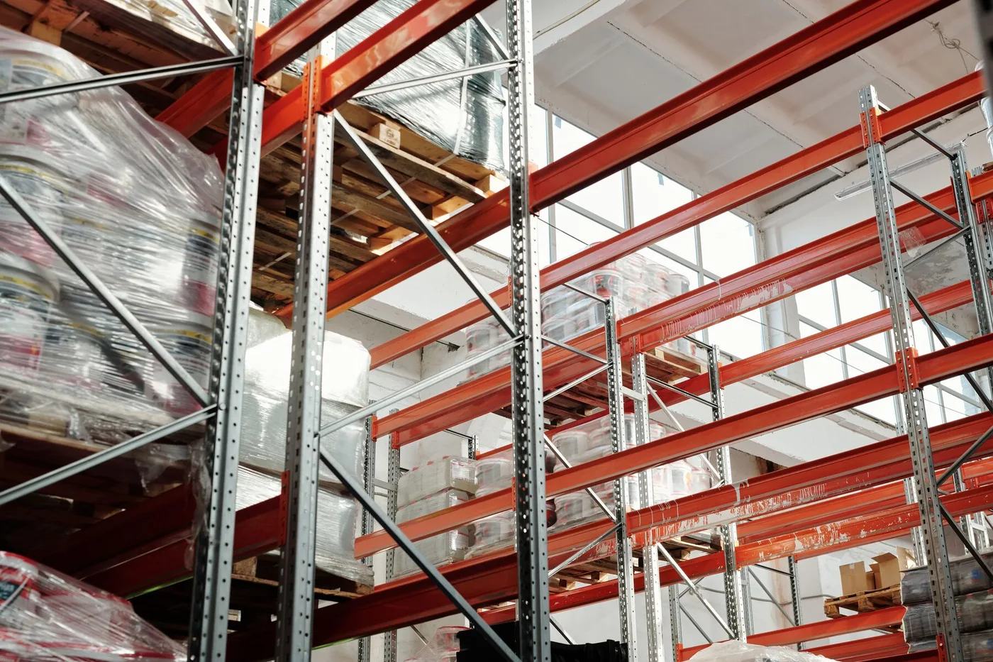 Organized warehouse rows of pallets and storage racks